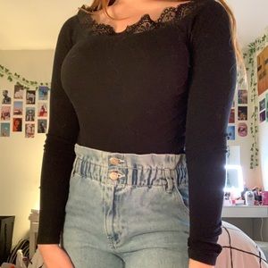 black body suit with lace around the neckline